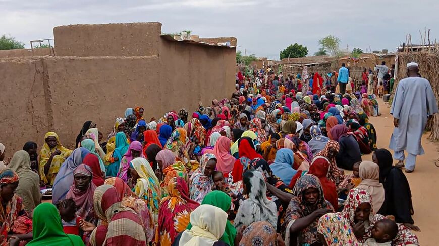 A file picture from August of people gathering to receive food in Sudan's El-Fasher, which has been under siege since 2023