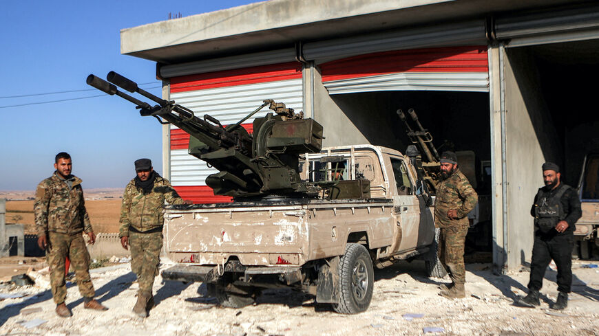 Fighters from the Turkish-backed Syrian National Army faction stand by a "technical" pickup truck at a position near the Tishrin Dam in the vicinity of Manbij, in the east of Syria's northern Aleppo province, on January 10, 2025 amidst ongoing battles with the Kurdish-led Syrian Democratic Forces (SDF).