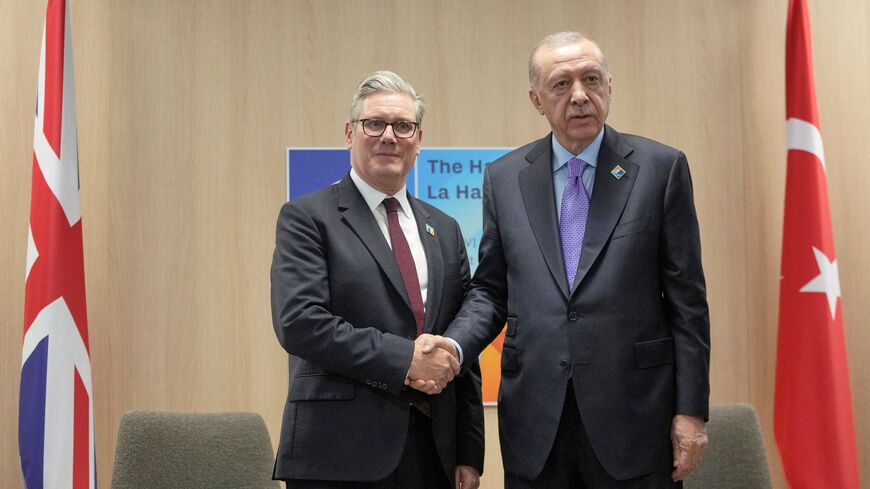 Britain's Prime Minister Keir Starmer (L) shakes hands with Turkey's President Recep Tayyip Erdogan prior to their meeting on the sideline of the North Atlantic Treaty Organization (NATO) summit in The Hague, on June 25, 2025. (Photo by Kin Cheung / POOL / AFP) (Photo by KIN CHEUNG/POOL/AFP via Getty Images)
