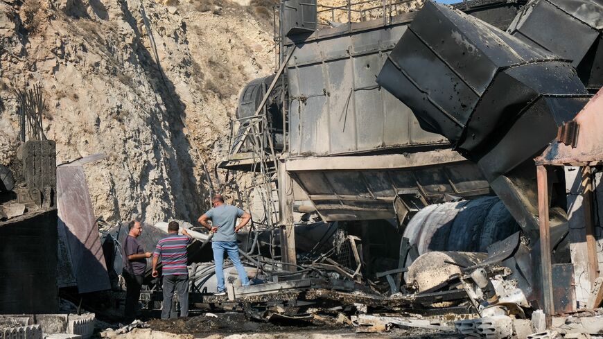 Men inspect the wreckage of a damaged cement factory following overnight Israeli airstrikes in Ansar, southern Lebanon, on Oct. 17, 2025.
