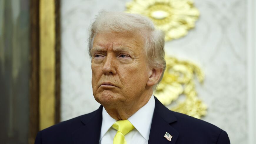 US President Donald Trump looks on during a press conference in the Oval Office of the White House, on Oct. 15, 2025, in Washington