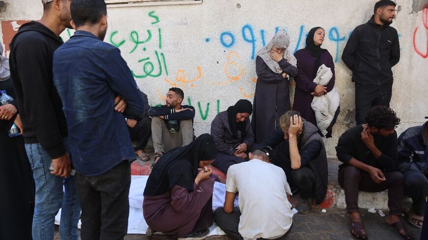 Palestinians mourn over the body of a relative who was killed in overnight Israeli strikes on Gaza