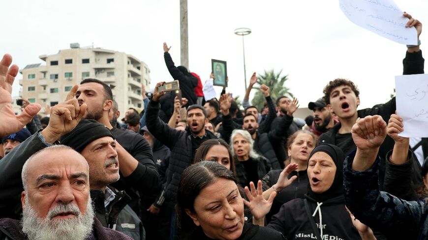 Demonstrators in Latakia's Al-Azhari Square protest against attacks targeting Syria's minority Alawite community
