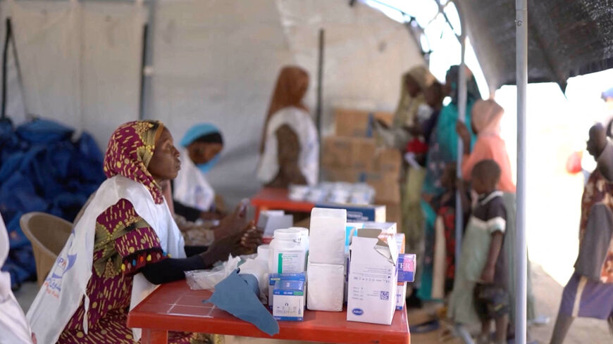 A medic waits in a makeshift clinic as displaced Sudanese gather after fleeing Al-Fashir city in Darfur, in Tawila, Sudan, October 29, 2025, in this still image taken from a Reuters' video. REUTERS/Mohamed Jamal