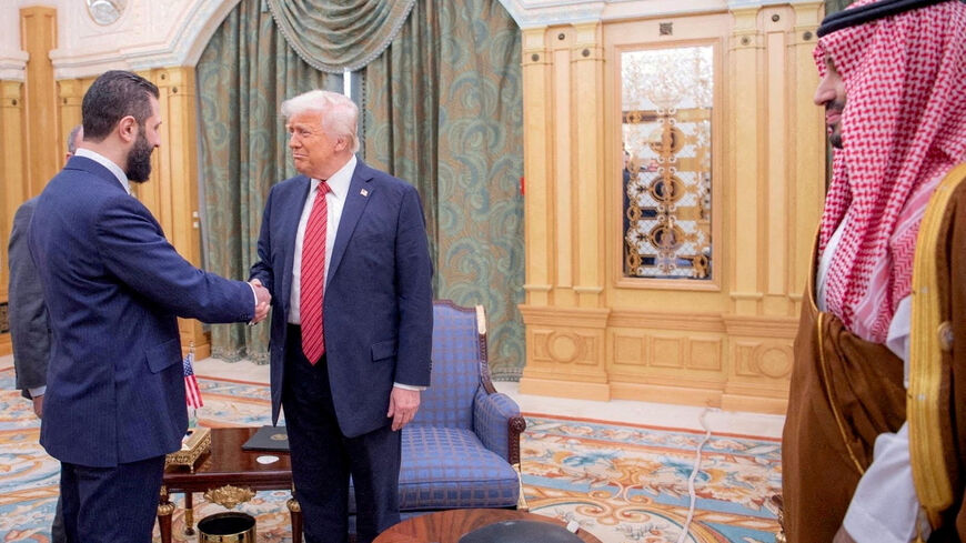 FILE PHOTO: U.S. President Donald Trump meets Syrian President Ahmed al-Sharaa in Riyadh, Saudi Arabia, in this handout released on May 14, 2025. Saudi Press Agency/Handout via REUTERS   THIS IMAGE HAS BEEN SUPPLIED BY A THIRD PARTY/File Photo