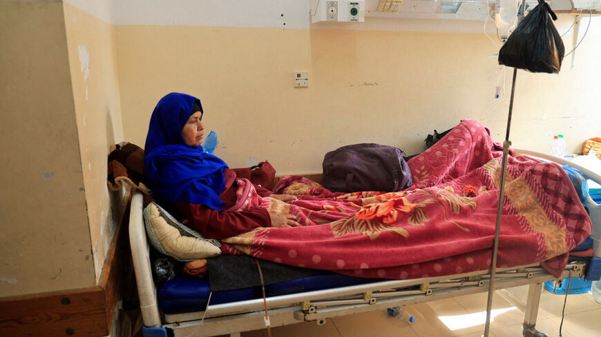A Palestinian woman lies on a bed as she receives treatment at Nasser Hospital in Khan Younis, southern Gaza Strip, November 10, 2025. REUTERS/Haseeb Alwazeer