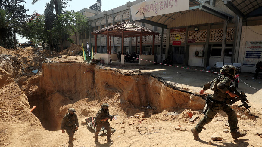 FILE PHOTO: Israeli soldiers walk out from a tunnel underneath the European Hospital in Khan Younis at the Gaza Strip, amid the ongoing ground operation of the Israeli army against Palestinian Islamist group Hamas, June 8, 2025. REUTERS/Ronen Zvulun/File Photo