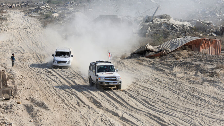 A Red Cross vehicle, escorted by a van driven by a Hamas militant, moves in an area within the so-called "yellow line" to which Israeli troops withdrew under the ceasefire, as Hamas says it continues to search for the bodies of deceased hostages seized during the October 7, 2023, attack on Israel, in Gaza City November 12, 2025. REUTERS/Dawoud Abu Alk