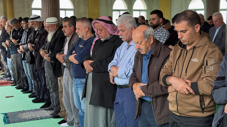 Palestinians attend Friday prayers in a mosque following an attack that local Palestinians said was carried out by Israeli settlers, in the village of Deir Istiya near Salfit in the Israeli-occupied West Bank November 14, 2025. REUTERS/Sinan Abu Mayzer