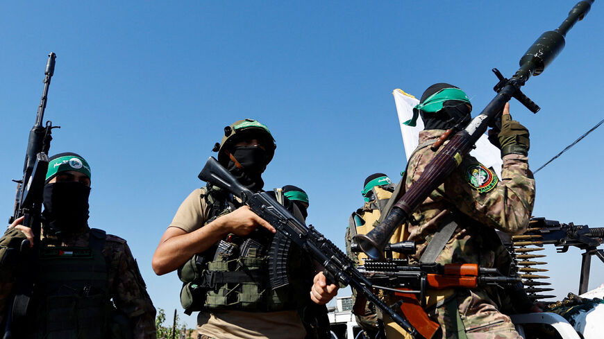 Palestinian fighters from the armed wing of Hamas take part in a military parade to mark the anniversary of the 2014 war with Israel, near the border in the central Gaza Strip, July 19, 2023. REUTERS/Ibraheem Abu Mustafa