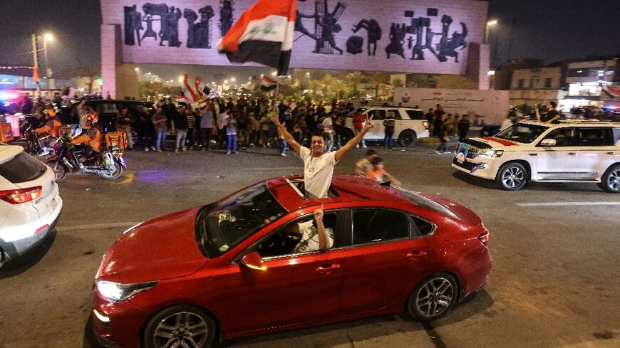 Supporters of incumbent Iraqi Prime Minister Mohammed Shia al-Sudani celebrate following the announcement of preliminary election results in Baghdad