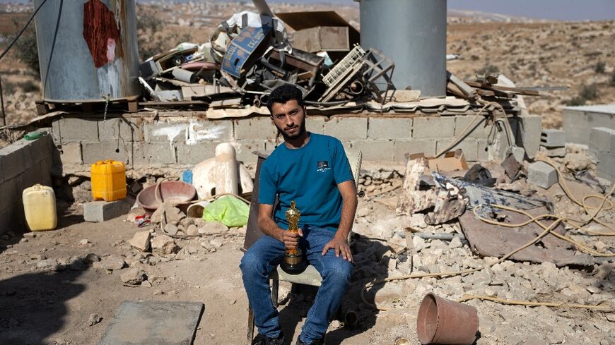 Basel Adra holds up his Oscar in the village of At Tuwani in the occupied West Bank