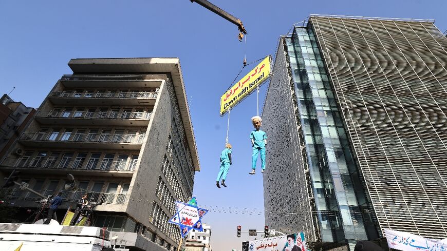 Protesters file pass hanging effigies of Donald Trump and Benjamin Netanyahu as Iran commemorates the 1979 storming of the US embassy