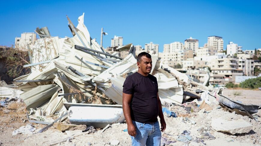 Yahya Abu Ghaliyeh stands in front of his demolished house near the town of Al-Eizariya, also known as Bethany