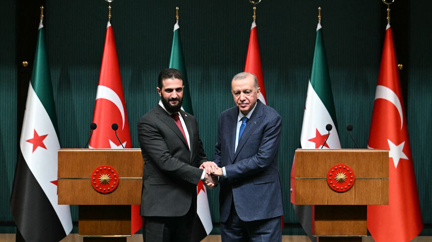 Turkish President Recep Tayyip Erdogan (R) and Syria's interim president Ahmed al-Sharaa shake hands during a joint press conference following their meeting at the Presidential Palace in Ankara, on Feb. 4, 2025. 
