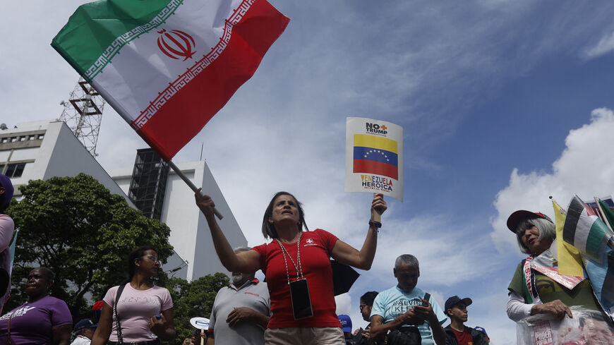 A woman waves an Iranian flag during a rally against Israel's attacks on Iran, in solidarity with the Palestinian people and to call for world peace in Caracas, on June 19, 2025. 