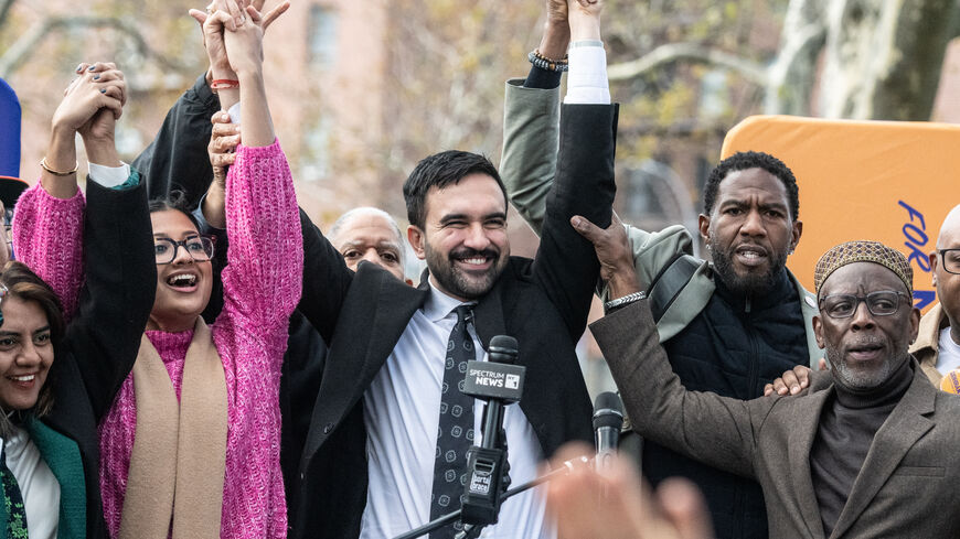 NEW YORK, NEW YORK - NOVEMBER 1: Democratic New York City mayoral candidate Zohran Mamdani (C) raises his hands during a campaign event with New York City elected officials on November 1, 2025 in the Queens borough of New York City. With only days left in the race for New York City's next mayor, Mamdani remains the front runner against Independent candidate, former New York Gov. Andrew Cuomo and Republican candidate Curtis Sliwa. (Photo by Stephanie Keith/Getty Images)