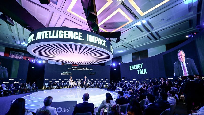 People sit listening as the Chairman and CEO of TotalEnergies Patrick Pouyanne speaks during the Abu Dhabi International Petroleum Exhibition & Conference in Abu Dhabi, on Nov. 3, 2025.