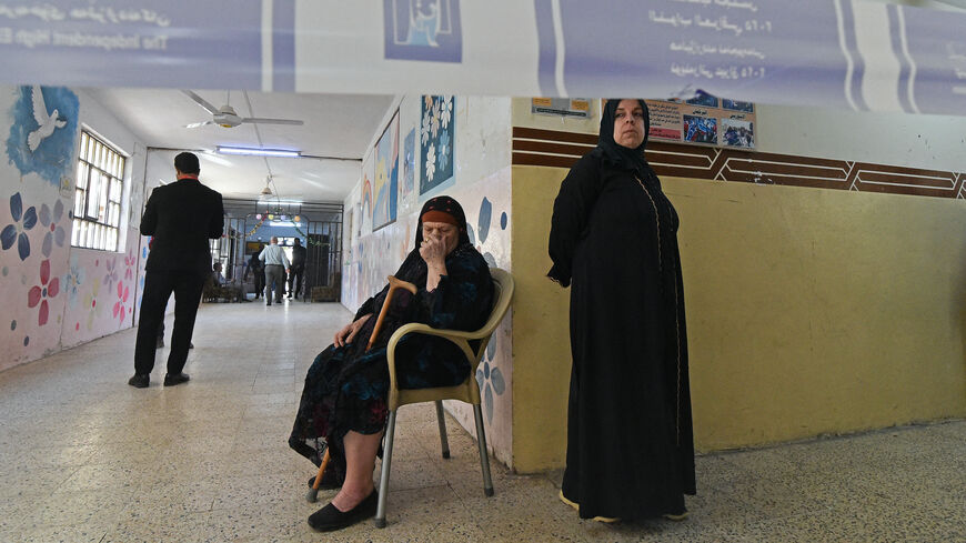 Iraqi voters wait to cast their ballots at the Al-Ghufran school, turned into a polling station in the northern Iraqi city of Mosul on Nov. 11, 2025 during Iraq's parliamentary elections. 
