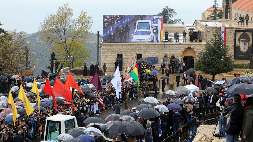 People watch Pope Leo XIV arriving to visit the tomb of Saint Charbel Makhlouf at the Monastery of Saint Maron, during his first apostolic journey, in Annaya, Lebanon December 1, 2025. REUTERS/Mohamed Azakir