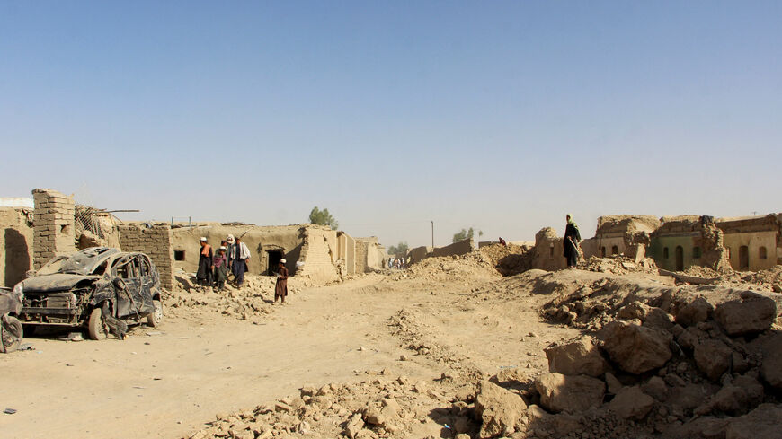 FILE PHOTO: People inspect houses and vehicles destroyed during an airstrike, following a temporary ceasefire, amid the conflict between Afghanistan and Pakistan, in Spin Boldak district of Kandahar Province, Afghanistan, October 16, 2025. REUTERS/Stringer/ File Photo