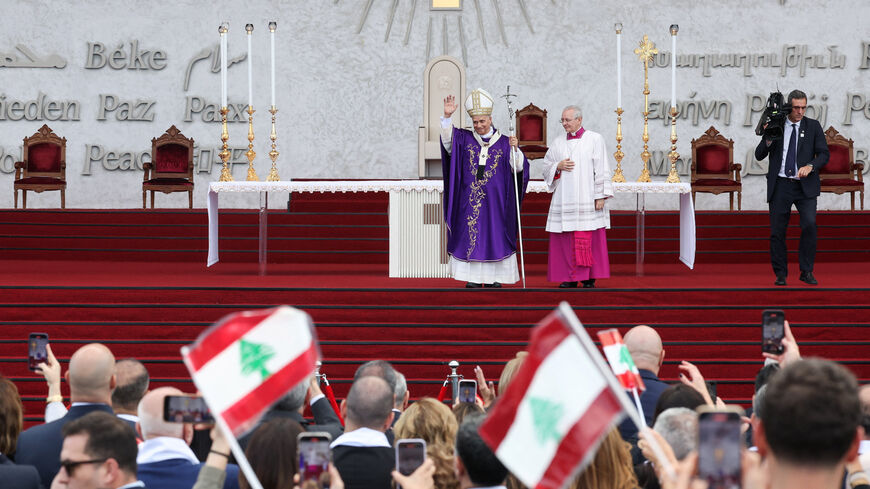 Pope Leo XIV waves to the crowd during a Holy Mass at the Waterfront, during his first apostolic journey, in Beirut, Lebanon December 2, 2025. REUTERS/Mohamed Azakir