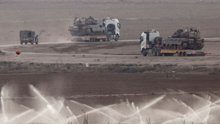 Trucks transport tanks on the Israeli side of the border with Gaza, Israel, November 18, 2025. REUTERS/Amir Cohen