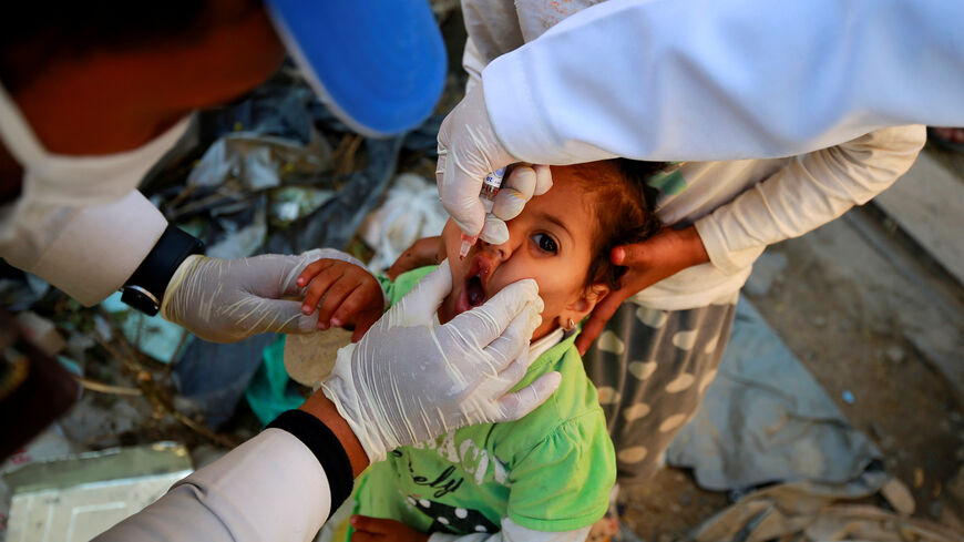 A girl receives a polio vaccine during a three-day immunization campaign in Sanaa, Yemen November 29, 2020. REUTERS/Nusaibah Almuaalemi