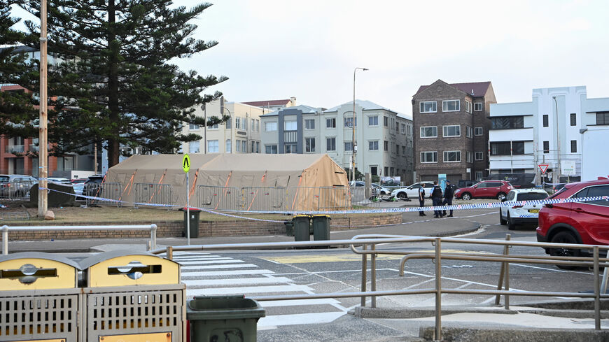 Police officers stand guard following the attack on a Jewish holiday celebration at Sydney's Bondi Beach, in Sydney, Australia, December 15, 2025. REUTERS/Flavio Brancaleone