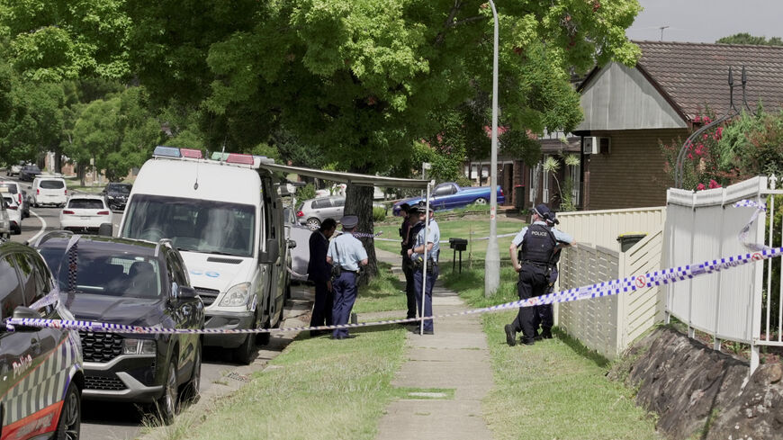 Police officers stand guard outside the house of the suspects of a shooting incident on a Jewish holiday celebration at Bondi Beach, in Bonnyrigg, Sydney, Australia, December 15, 2025. REUTERS/Alasdair Pal/File Photo