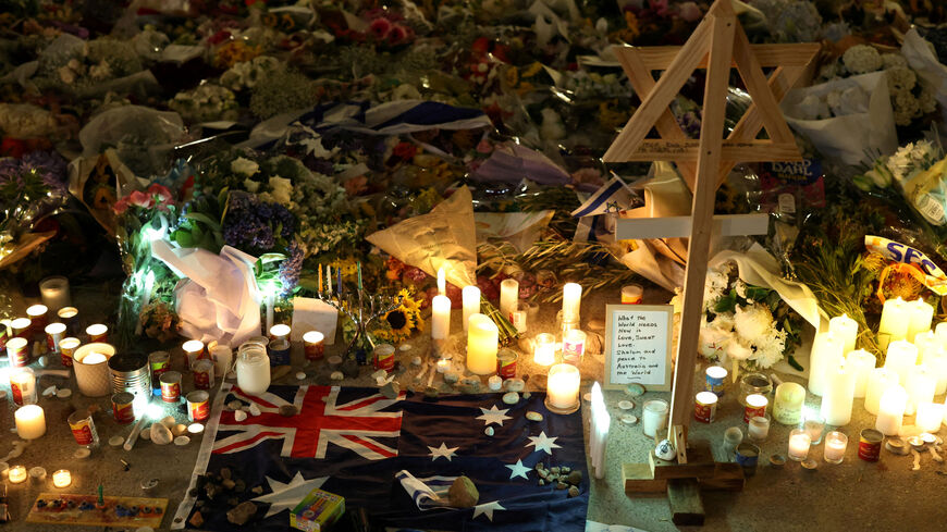 FILE PHOTO: An Australian flag sits amongst floral tributes honouring the victims of a shooting at Jewish holiday celebration on Sunday at Bondi Beach, in Sydney, Australia, December 16, 2025. REUTERS/Hollie Adams/File Photo