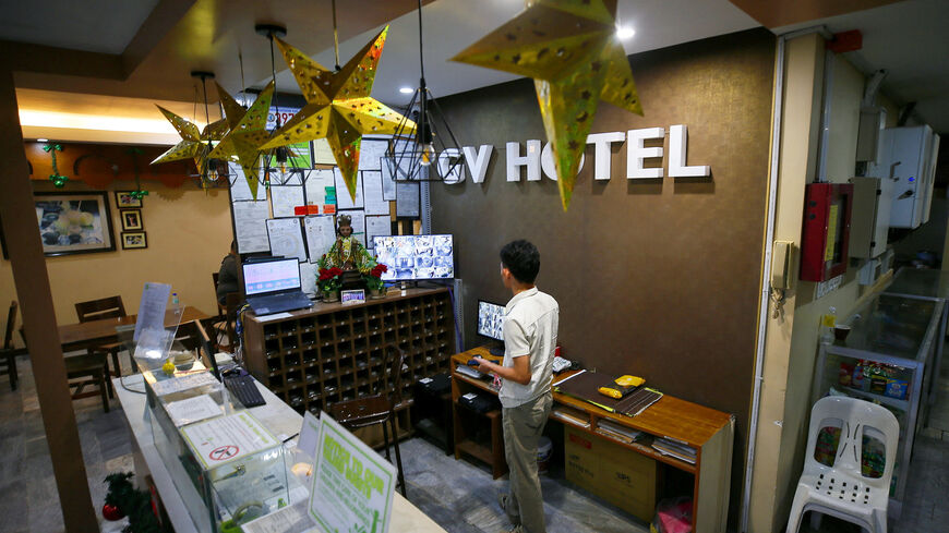 A hotel worker looks at the CCTV monitor from the lobby of GV Hotel, where the suspected gunmen from Sydney's Bondi Beach shooting attack at a Hanukkah event had allegedly stayed when they travelled to the Philippines last month, in Davao City, Philippines, December 17, 2025. REUTERS/Marconi B. Navales