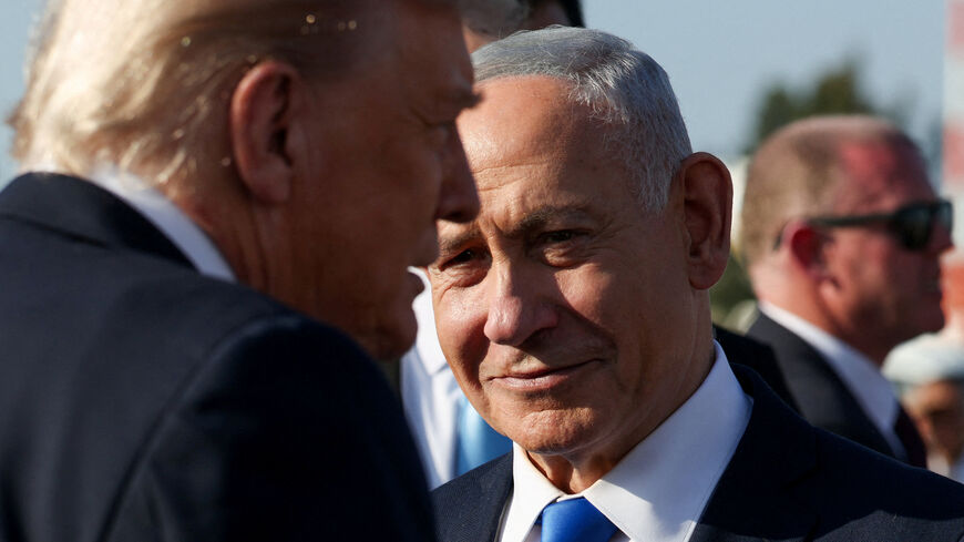 Israeli Prime Minister Benjamin Netanyahu looks on next to U.S. President Donald Trump as Trump leaves Israel en route to Sharm El-Sheikh, Egypt, to attend a world leaders' summit on ending the Gaza war, amid a U.S.-brokered prisoner-hostage swap and ceasefire deal between Israel and Hamas, at Ben Gurion International Airport in Lod, Israel, October 13, 2025. REUTERS/Evelyn Hockstein