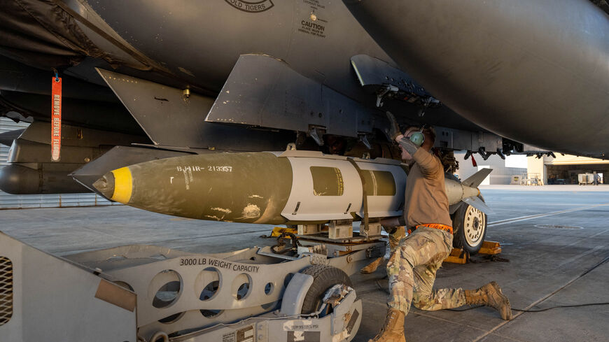 A U.S. Airman attaches a GBU-31 munitions system to an F-15E Strike Eagle in the U.S. Central Command area of responsibility, December 19, 2025, in support of Operation Hawkeye Strike as the U.S. military launched large-scale strikes against dozens of Islamic State targets in Syria in retaliation for an attack on U.S. personnel, U.S. officials said.  U.S. Air Force Photo/Handout via REUTERS