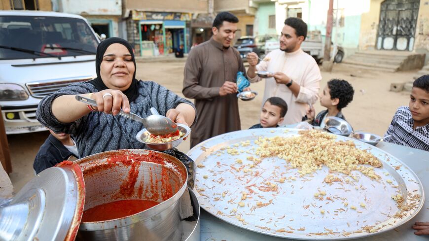 A woman sells koshary after the Eid prayer in Abu Sir village on April 21, 2023, in Giza, Egypt.