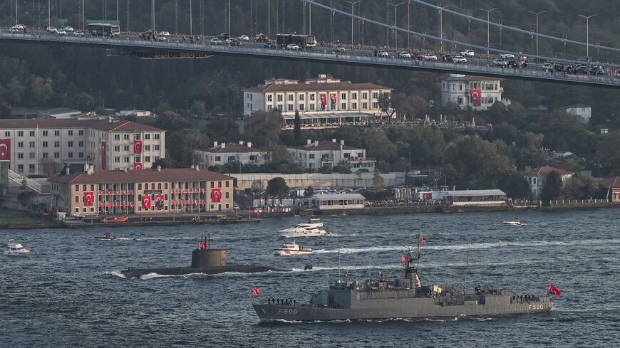 Turkish naval forces patrol vessel TCG F 500 and an unidentified submarine (back) sail during a military naval parade on the Bosphorus in Istanbul on Oct. 29, 2023.