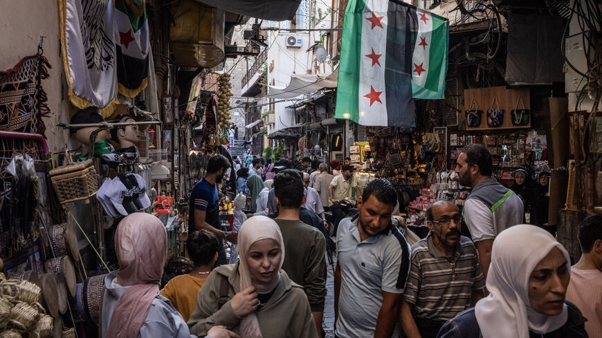 People shop in a market on June 17, 2025 in Damascus, Syria. 