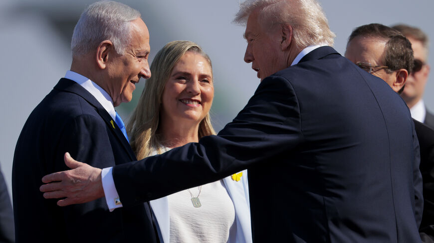 TEL AVIV, ISRAEL - OCTOBER 13: U.S. President Donald Trump (2R) is welcomed by Israeli Prime Minister Benjamin Netanyahu (L) at Ben Gurion International Airport on October 13, 2025 in Tel Aviv, Israel. President Trump is visiting the country hours after Hamas released the remaining Israeli hostages captured on Oct. 7, 2023, part of a US-brokered ceasefire deal to end the war in Gaza. (Photo by Chip Somodevilla/Getty Images)