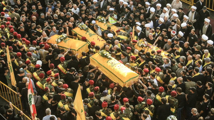 Supporters of Lebanon's Shiite militant group Hezbollah carry the coffins of militants killed in recent Israeli attacks during their funeral in the southern city of Nabatiyeh on November 2, 2025. Hundreds of people gathered in south Lebanon's Nabatiyeh on November 2, 2025 to mourn five Hezbollah members killed in recent Israeli attacks, an AFP correspondent said, as Israel warned of intensifying attacks against the Iran-backed group. On November 1, an Israeli strike killed four people in Kfar Rumman, Nabati
