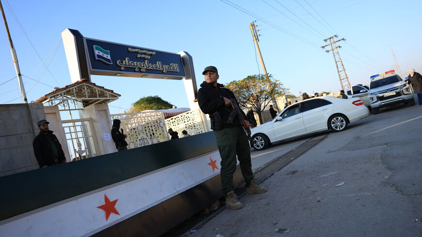Security personnel from the Syrian Ministry of Interior stand outside the Justice Palace ahead of the first trial of more than a dozen suspects linked to massacres that left hundreds dead in Syria's Alawite coastal heartland earlier this year, in Aleppo on November 18, 2025. The first trial of more than a dozen suspects linked to massacres that left hundreds dead in Syria's Alawite coastal heartland earlier this year began on November 18, an AFP journalist in the courtroom said. The massacres in March, whic