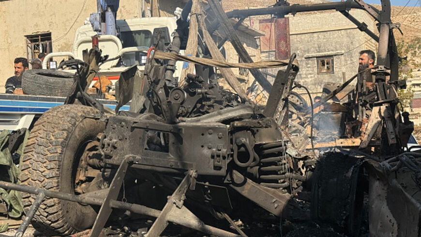 A crane removes a burnt Israeli Humvee from a street in the southern Syrian village of Beit Jin on November 28, 2025. Israeli forces killed 10 people on November 28, 2025 in an operation in southern Syria, the deadliest since Bashar al-Assad's fall from power nearly a year ago, which they said was targeting an Islamist group. The Israeli army said an exchange of fire in an operation to detain militants from neighbouring Lebanon in the Syrian village of Beit Jin left six Israeli soldiers wounded, three of th