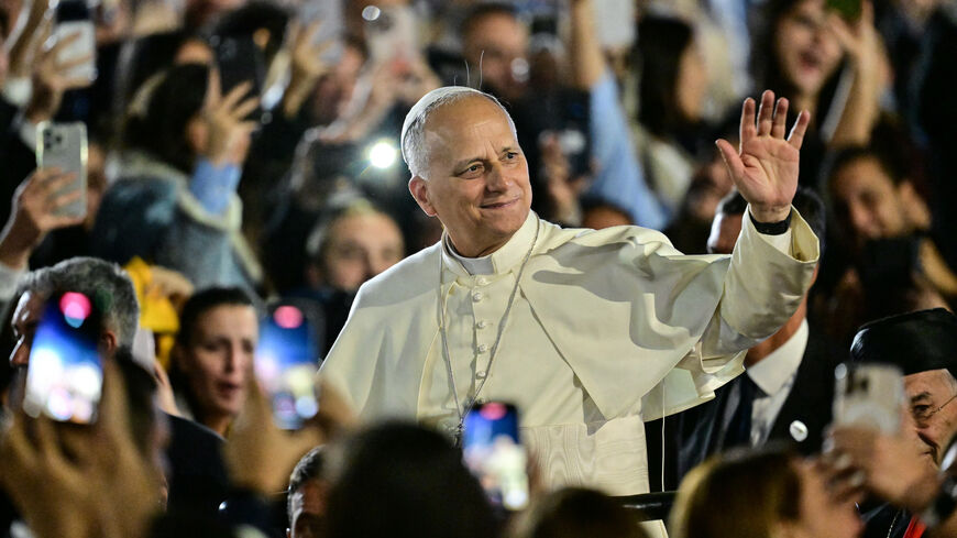 Pope Leo XIV waves to a crowd of youths upon his arrival at the Maronite Patriarchate in Bkerke, north of the capital Beirut, on December 1, 2025. Leo prayed for peace in Lebanon and the region on December 1 on day two of his trip to the multi-confessional country, with joyful Lebanese welcoming the pontiff at two famous pilgrimage sites. (Photo by Giuseppe CACACE / AFP via Getty Images)