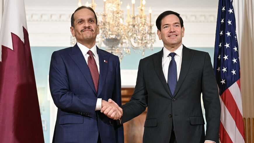 US Secretary of State Marco Rubio (R) shakes hands with Qatari Prime Minister and Foreign Minister Mohammed bin Abdulrahman al-Thani at the State Department in Washington, on Dec. 17, 2025. 