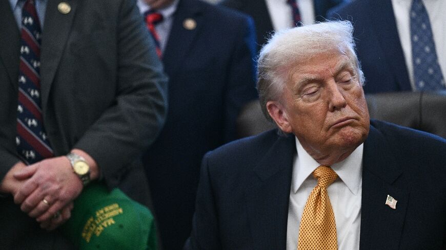 US President Donald Trump looks on before signing a bill on January 14, 2026 at the White House, where he discussed tensions with Iran 
