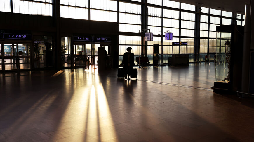 A passenger arrives to a terminal at Ben Gurion International Airport in Lod near Tel Aviv, Israel, January 25, 2021. REUTERS/Ronen Zvulun