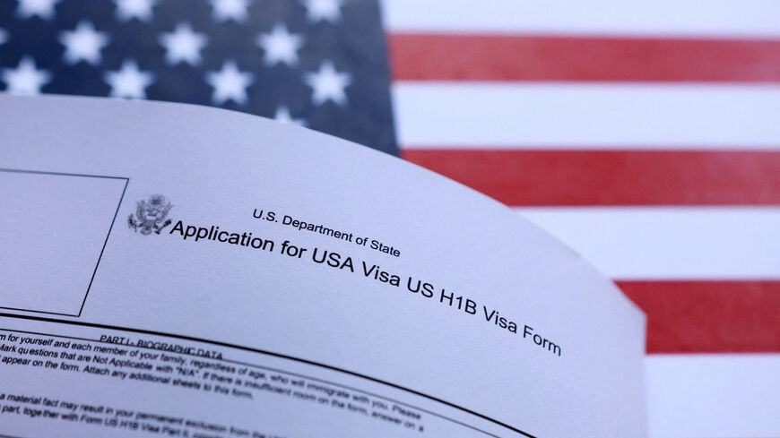 FILE PHOTO: U.S. flag and U.S. H-1B Visa application form are seen in this illustration taken September 26, 2025. REUTERS/Dado Ruvic/Illustration/File Photo