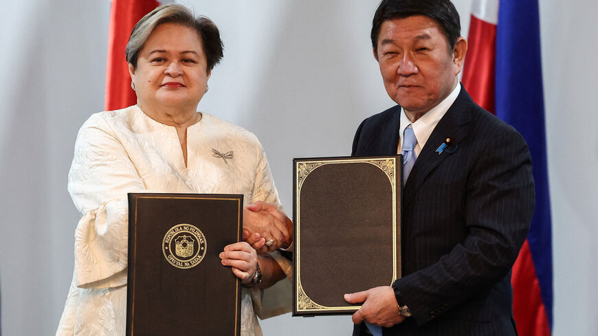 Philippine Foreign Minister Ma. Theresa P. Lazaro and Japanese Foreign Minister Toshimitsu Motegi shake hands while holding signed bilateral agreements ahead of their joint press conference in Pasay City, Metro Manila, Philippines, January 15, 2026. REUTERS/Eloisa Lopez