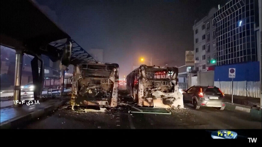 Burnt vehicles lie on the road following unrest sparked by dire economic conditions, in a place given as Tehran, Iran, January 10, 2026, in this screengrab from Iran's state media broadcast footage. IRIB via WANA(West Asia News Agency)