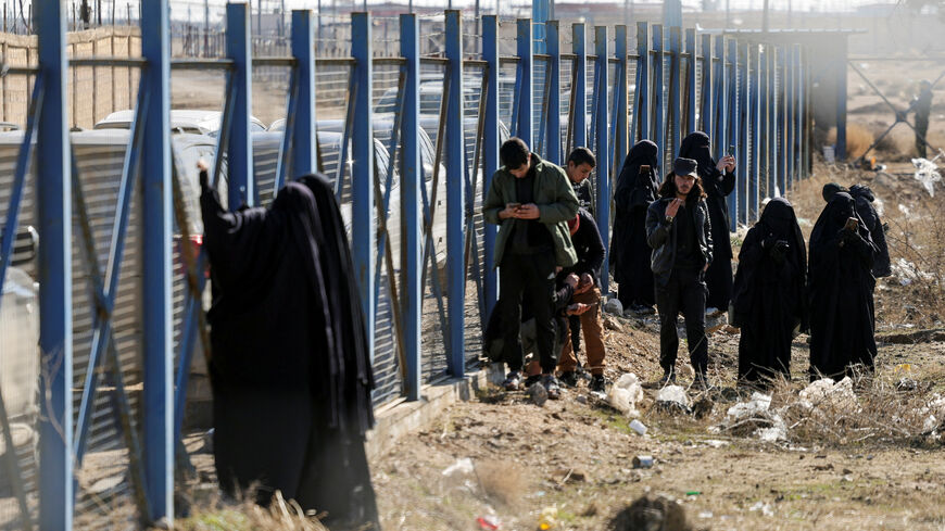 A group of detainees gather at al-Hol camp after the Syrian government took control of it following the withdrawal of Syrian Democratic Forces (SDF), in Hasaka, Syria, January 21, 2026. REUTERS/Khalil Ashawi
