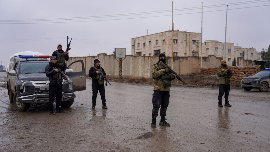 Members of the Syrian security forces stand guard outside al-Aqtan prison, where some Islamic State detainees are held, in Raqqa, Syria January 23, 2026. REUTERS/Karam al-Masri